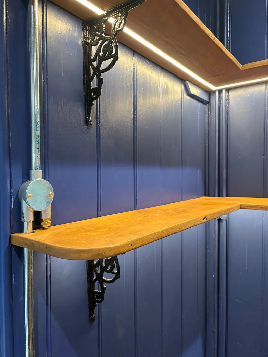 Warm white LED tape lighting integrated into timber shelving