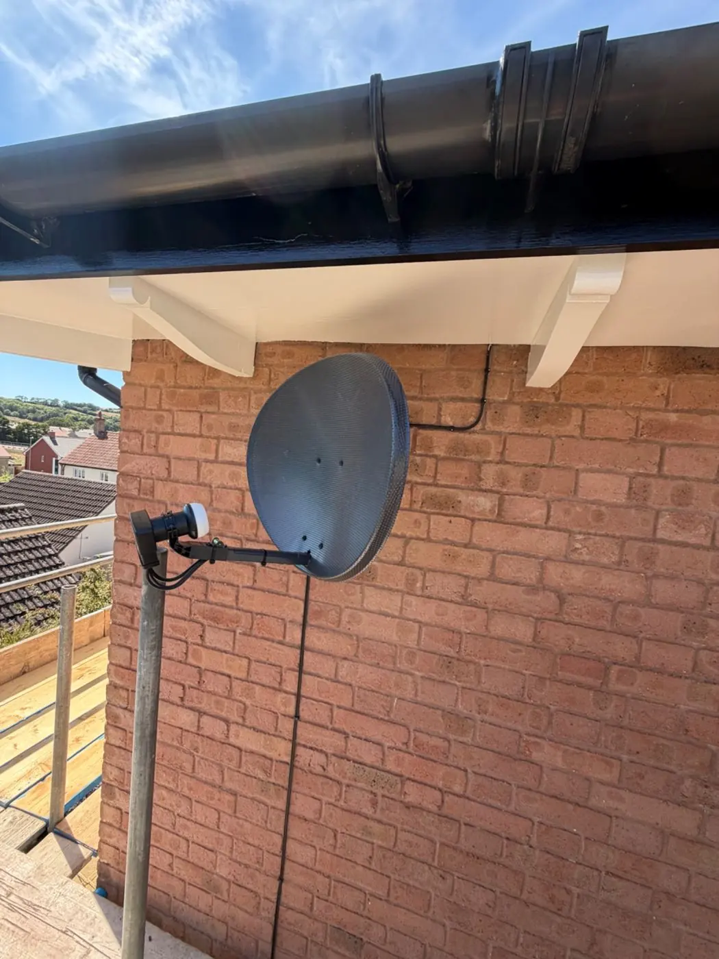 Satellite dish installation on an exterior wall
